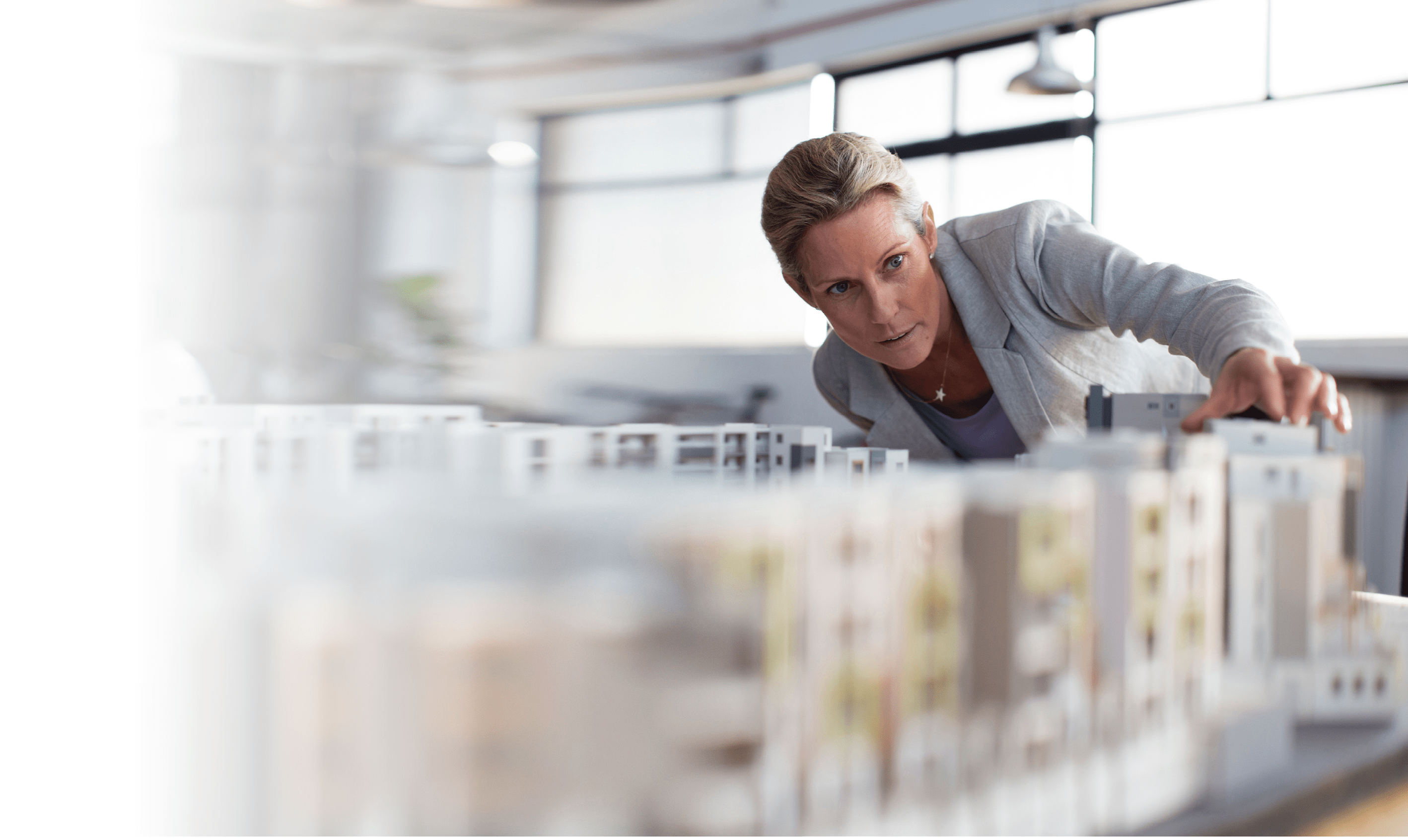 Caucasian architect examining architectural model in office