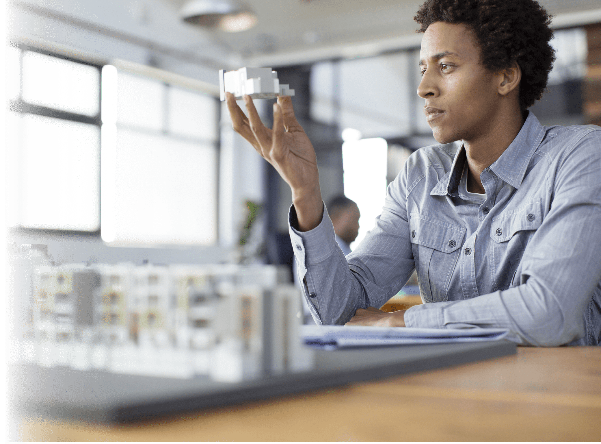 Mixed race architect examining architectural model in office