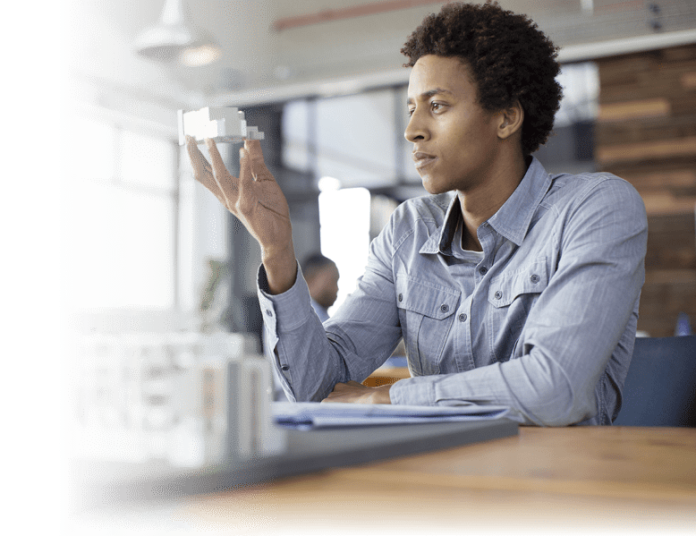 Mixed race architect examining architectural model in office