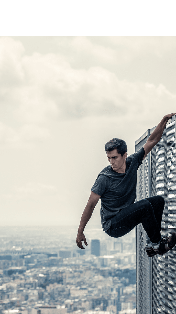 Urban parkour Man climbing fence