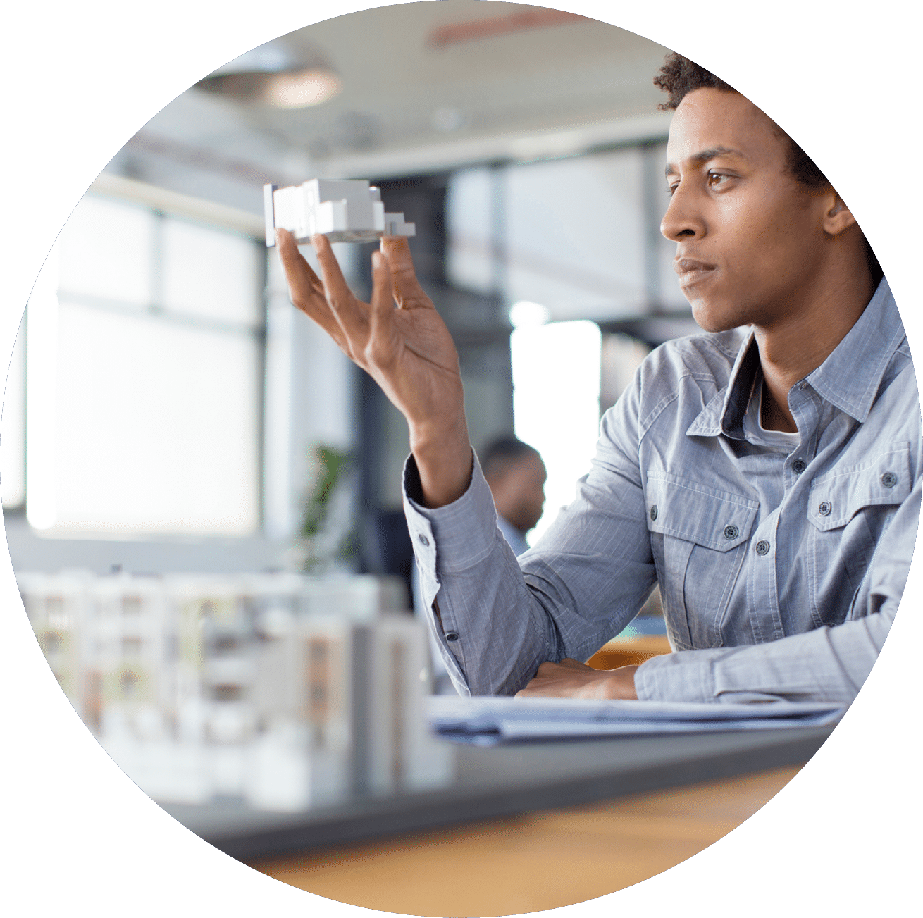 Mixed race architect examining architectural model in office