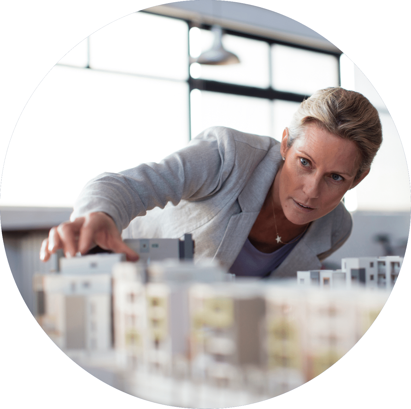 Caucasian architect examining architectural model in office