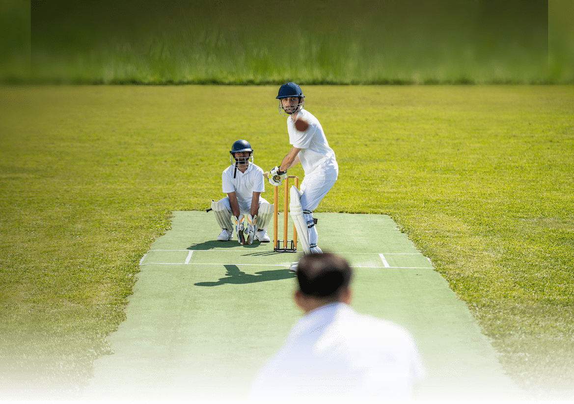 Photo of a cricket batsman ready to strike the ball that was thrown by the