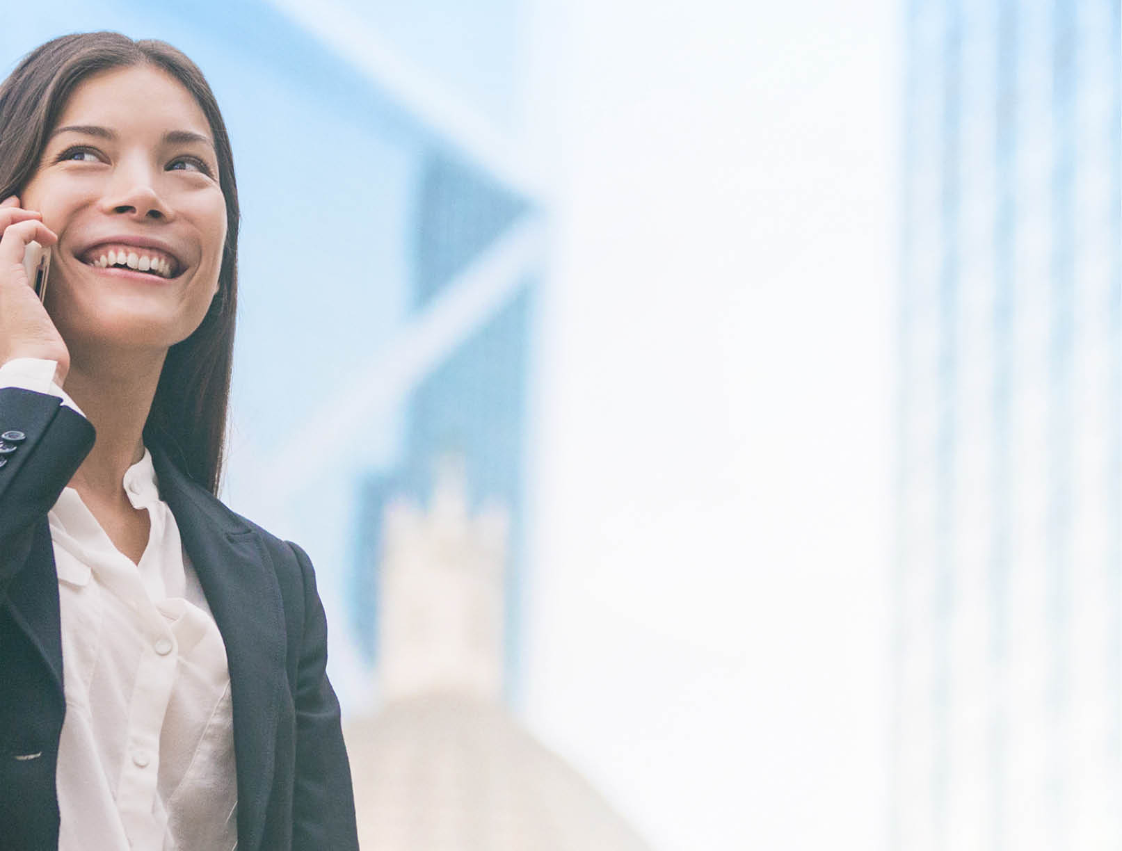 Asian businesswoman talking on mobile phone in Hong Kong cityscape background panoramic banner  Young chinese woman calling on smartphone happy  Multiracial Chinese Caucasian lawyer 